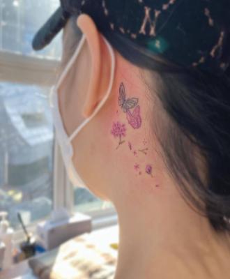Subtelny tatuaż za uchem